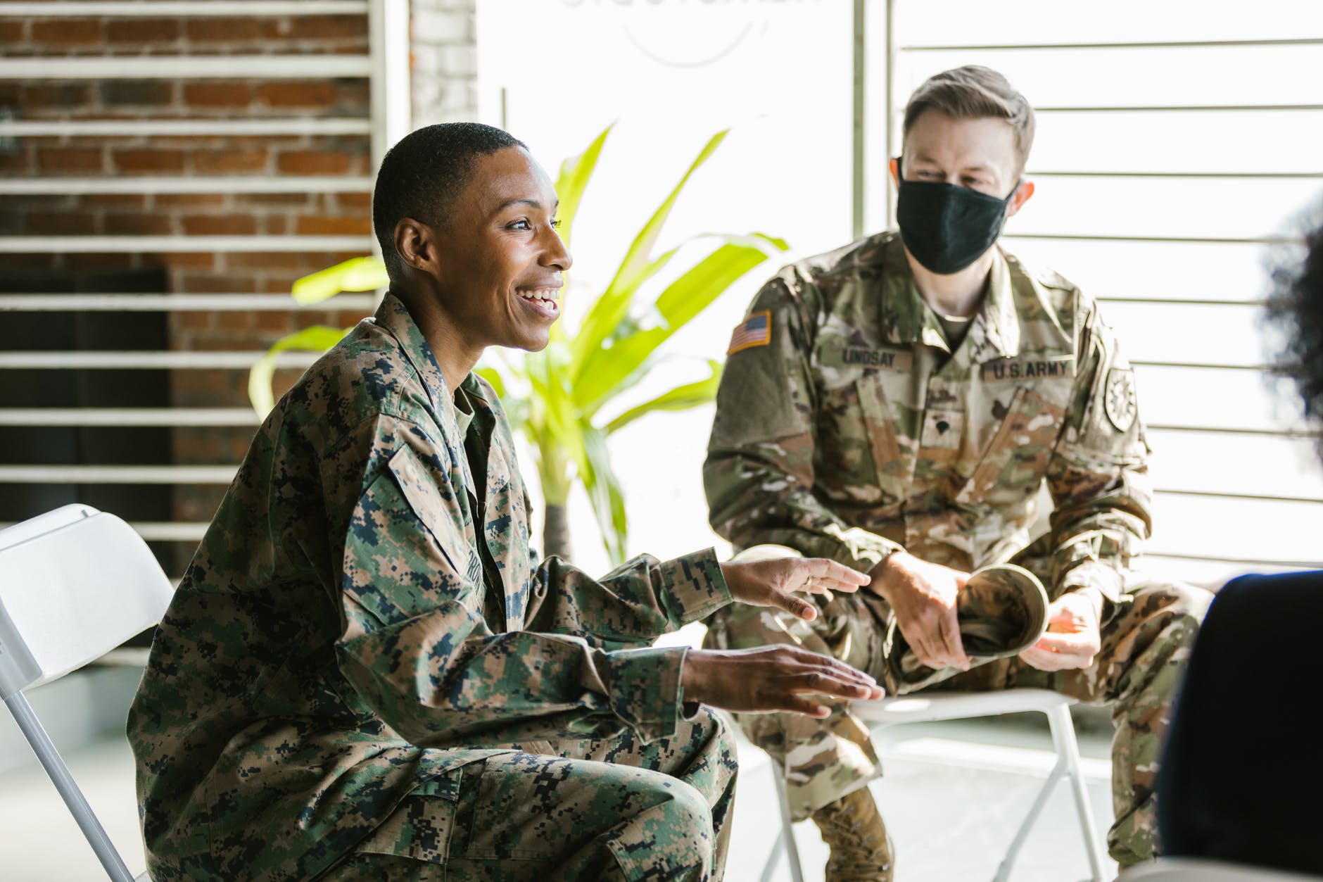 photo of soldiers sitting on folding chairs
