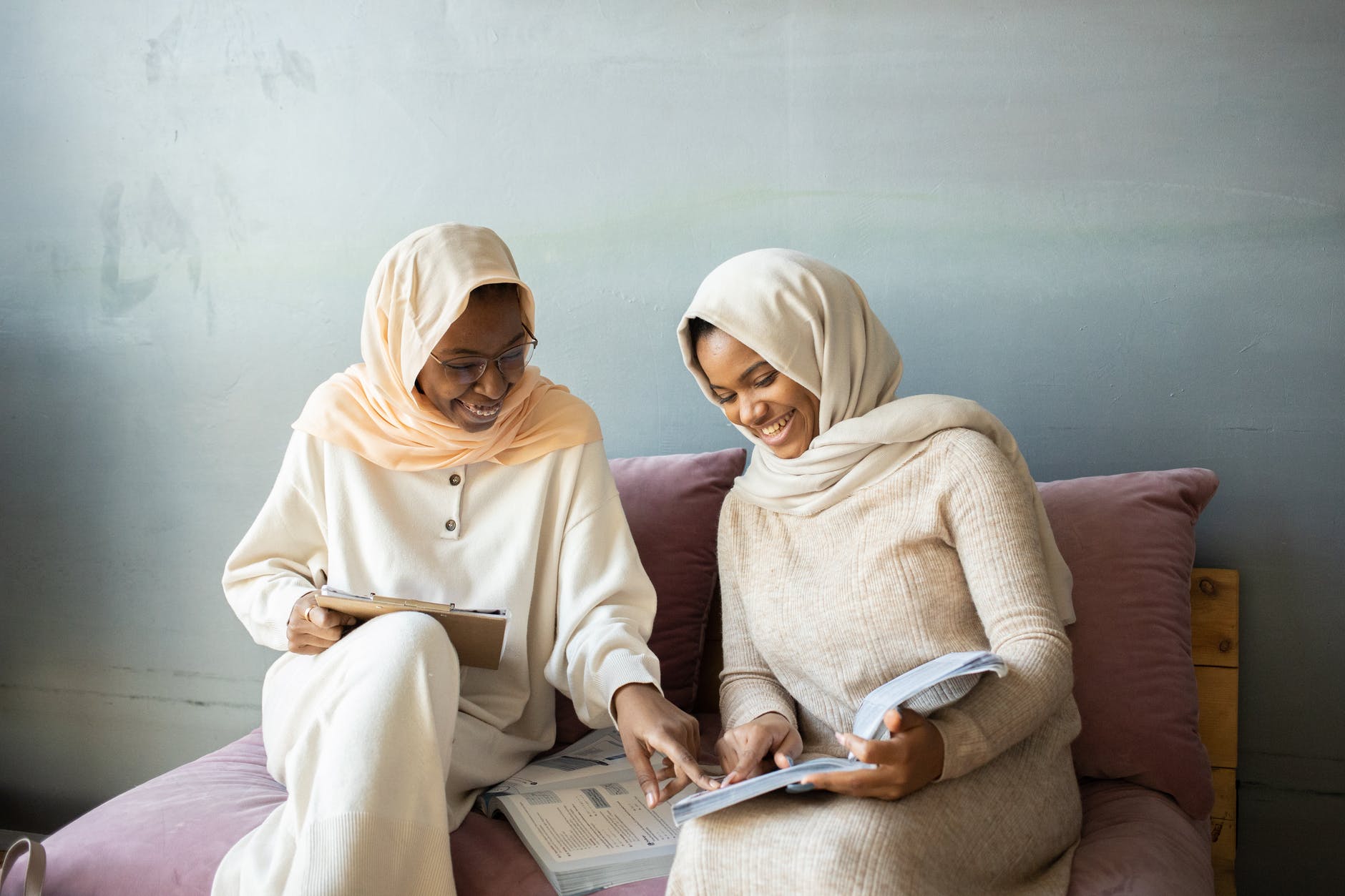woman in white hijab reading book